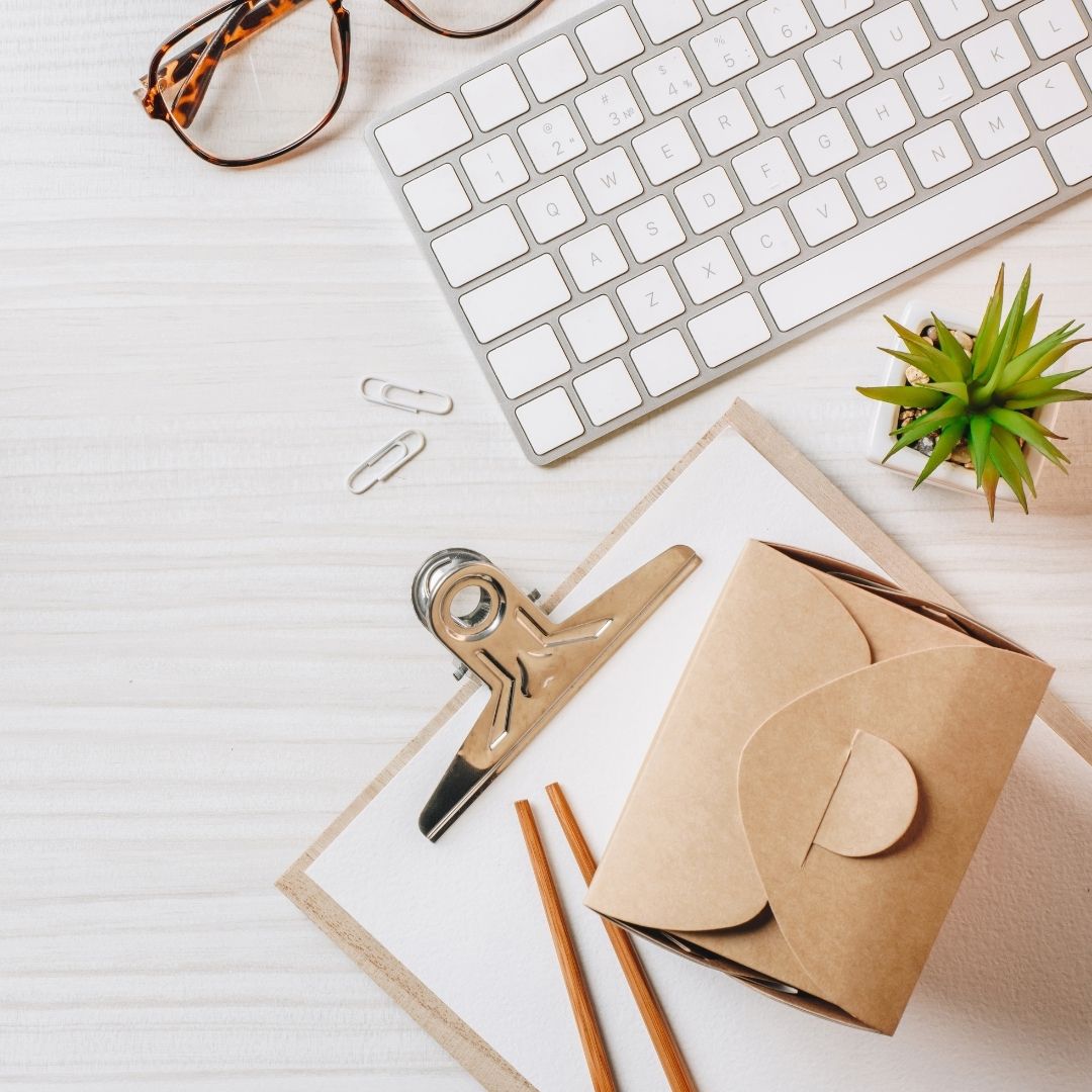 a white paper clip, eyeglasses, and a keyboard